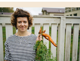 Female Farmer Harvesting Carrots In Garden